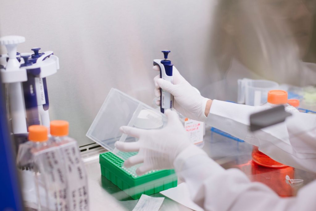 Scientist filling pipettes