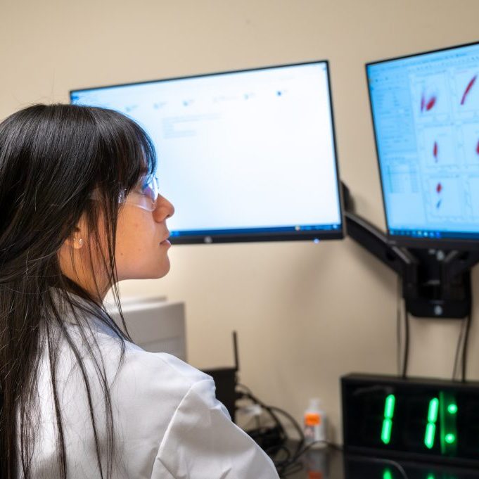 Scientist viewing info on a monitor